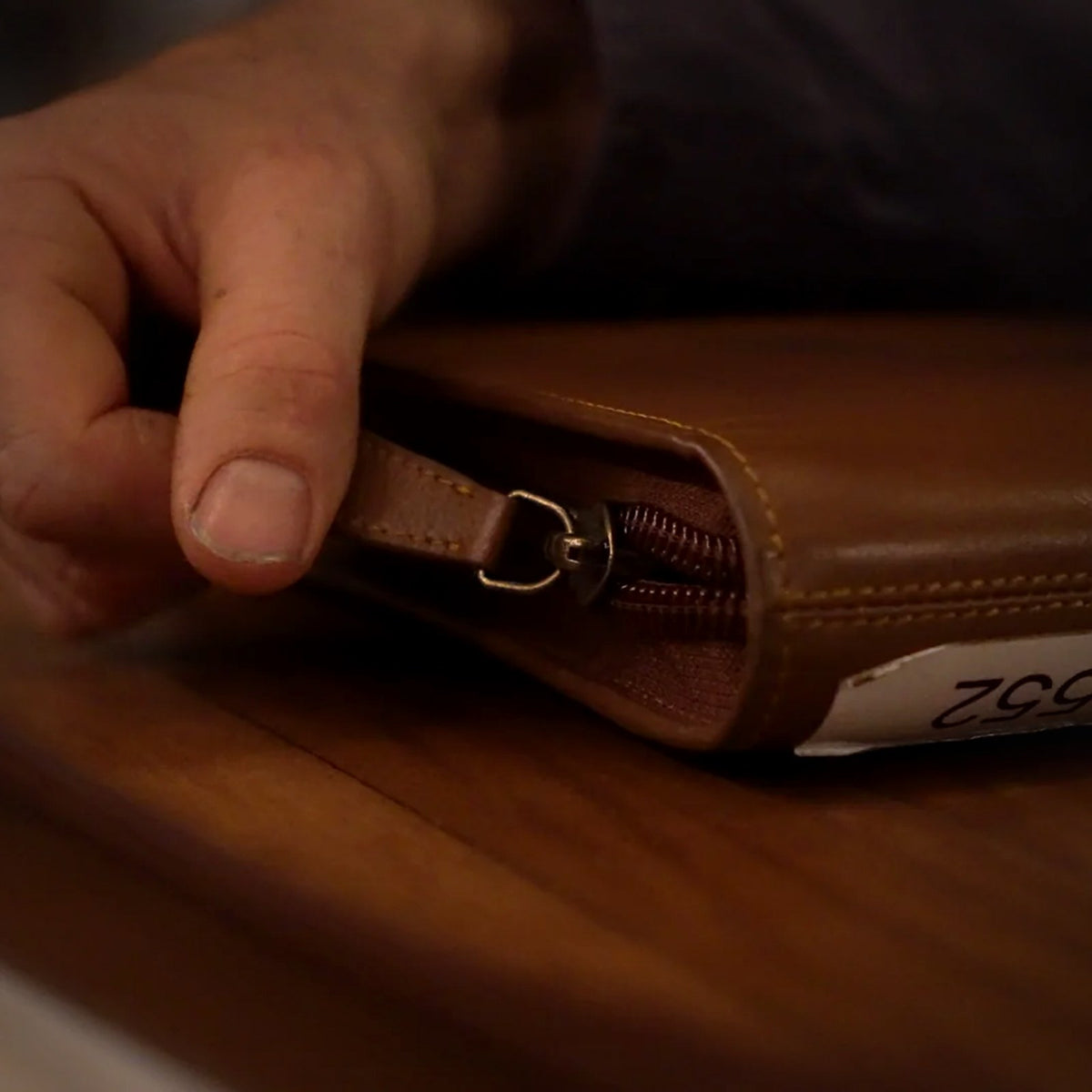 Zipping the Trade Hub leather work folder shut
