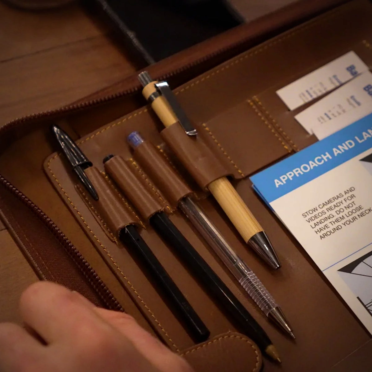 Pens held in the leather pen loops of the Trade Hub work folder