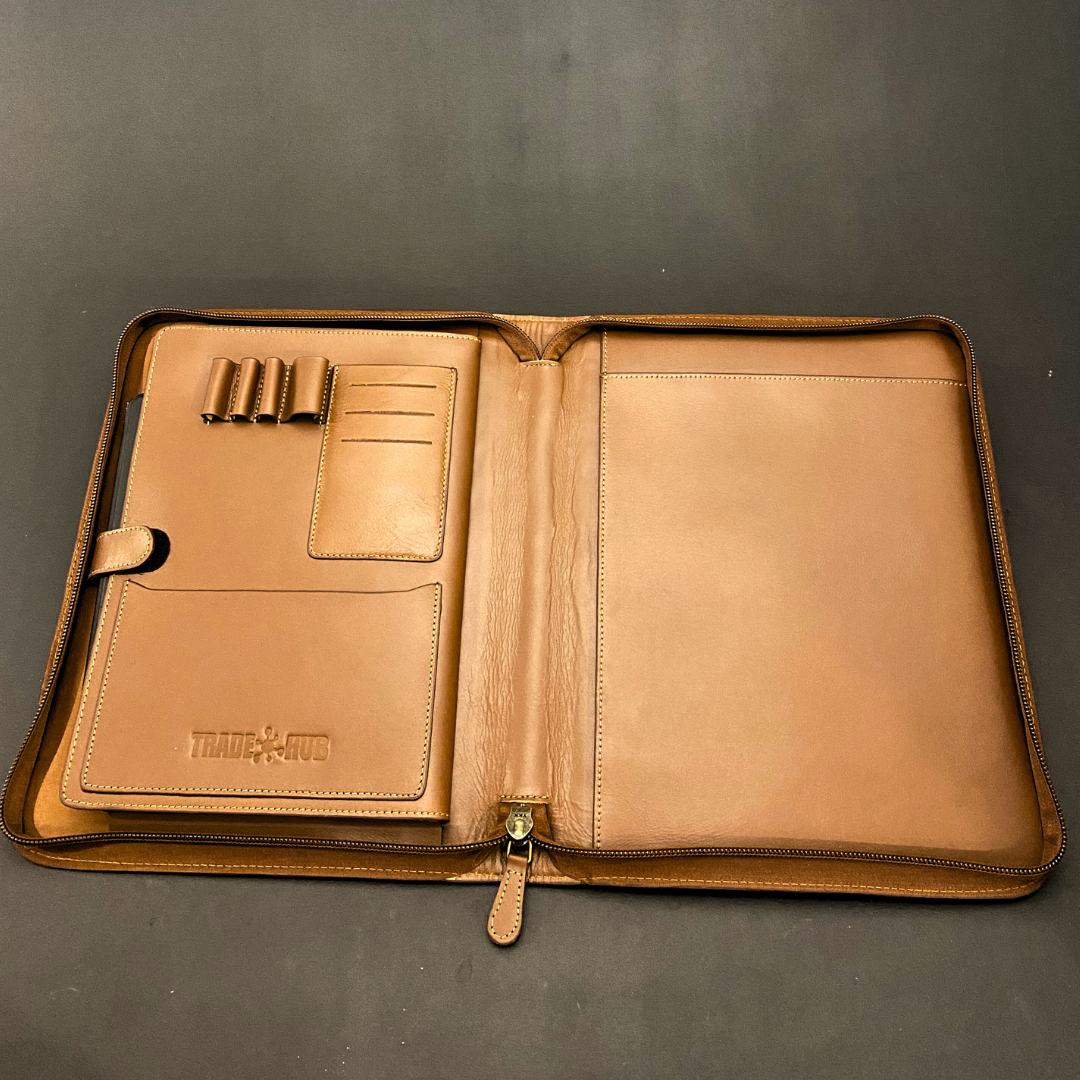 Empty TradeHub folder showing card slots, pen loops and compartments on black background