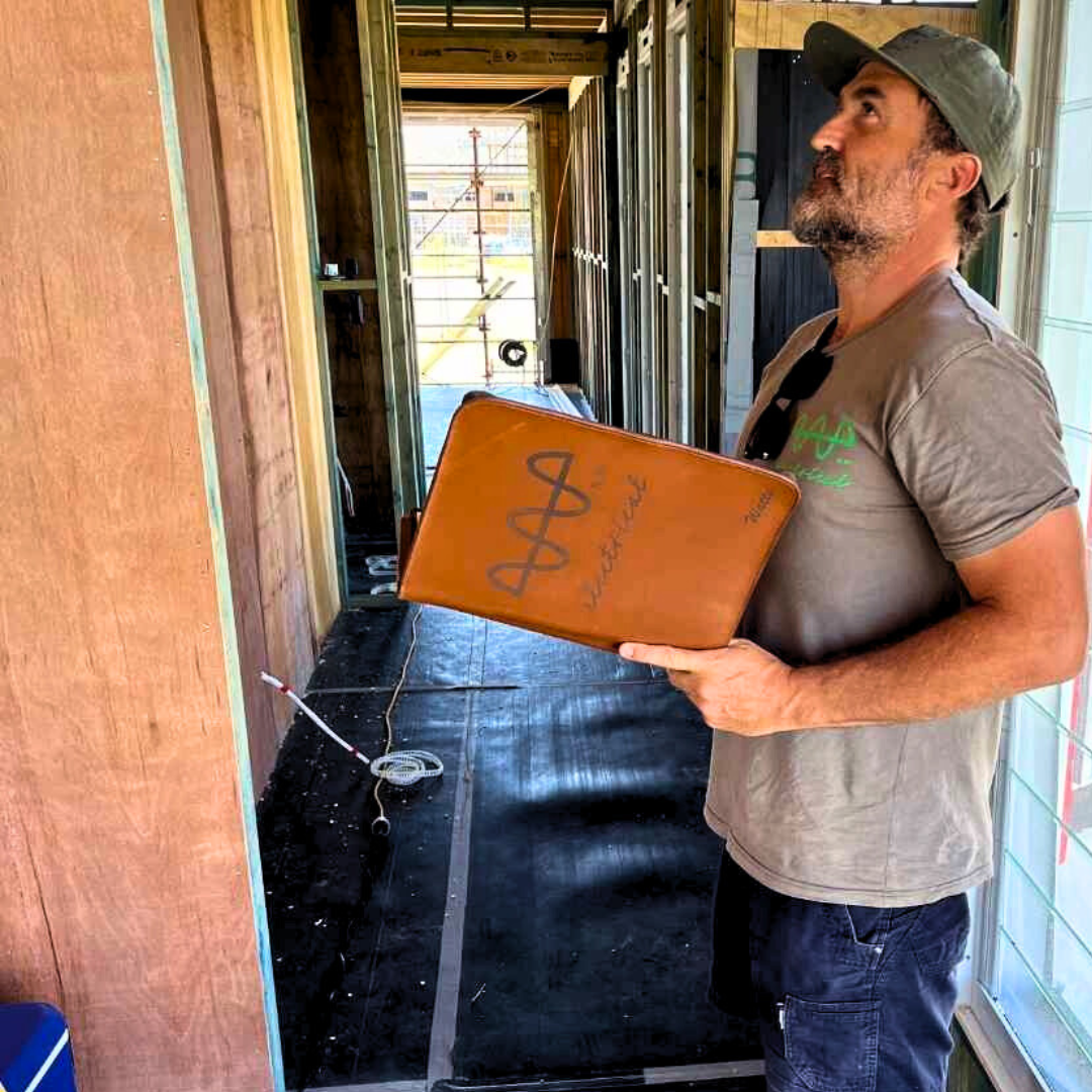 Tradesman on-site holding custom engraved TradeHub folder