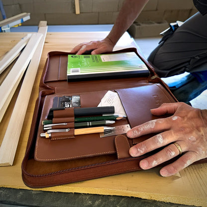 Trade Hub work folder open on site with tablet, pens and notebook